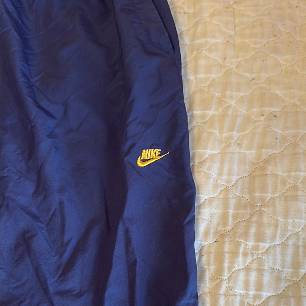 Nike Navy Blue Track Pants with Yellow Logo. Jogging pants with zipper on legs